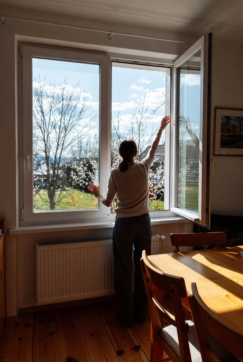 seasonal pollen allergy — girl closes window